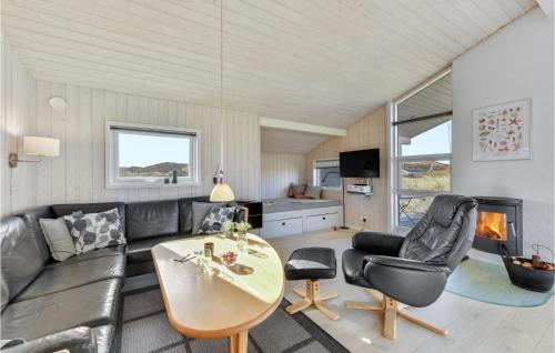 a living room with a couch and a table at Holiday Home Skodbjergevej Hvide Sande X in Havrvig