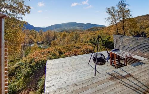a porch with a swing and a view of the mountains at Cozy Home In Vikeså With House Sea View in Vikeså