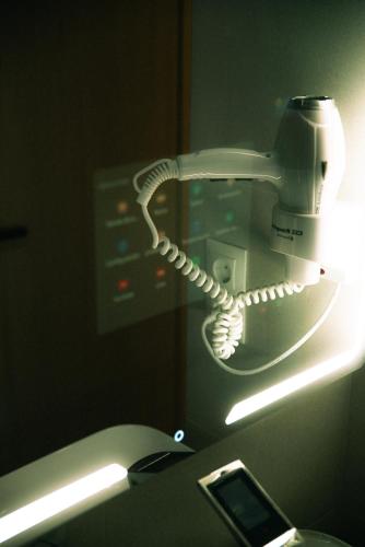 a phone in a room with a light at Futurotel Sevilla in Seville