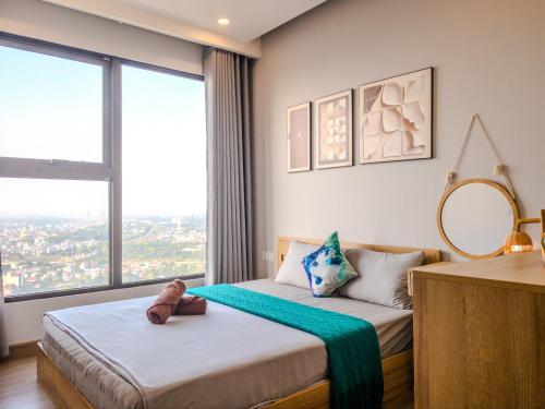 a bedroom with two beds and a large window at Homestay Ecopark Hung Yen by QMP in HÆ°ng YÃªn