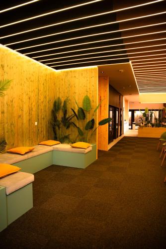 a lobby with two benches in a room with at Futurotel Sevilla in Seville