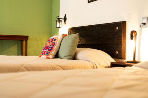 two beds with pillows on them in a bedroom at Casa de hospedaje -La Abadía de San Pedro in Guadalajara