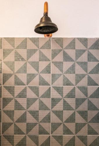 a light fixture hanging over a tiled floor at Casa de hospedaje -La Abadía de San Pedro in Guadalajara