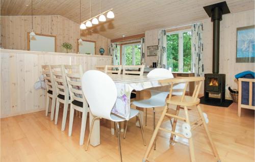 a kitchen and dining room with a table and chairs at Holiday Home Ruggårdsvej Højby Denm in Lumsås