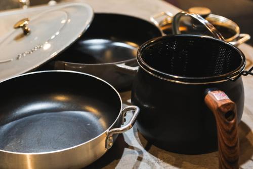 a group of pots and pans on a table at Sunrise Villa Oarai in Natsumi