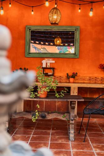 a room with a table with potted plants and a window at Casa de hospedaje -La Abadía de San Pedro in Guadalajara