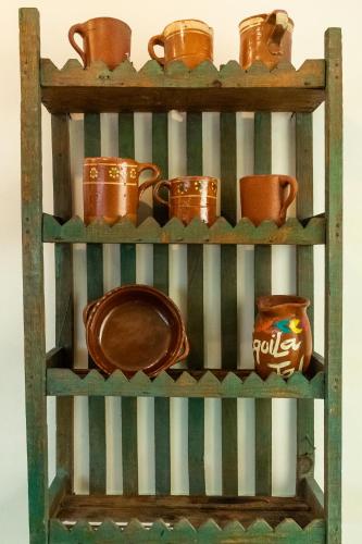a wooden shelf with pots and pans on it at Casa de hospedaje -La Abadía de San Pedro in Guadalajara