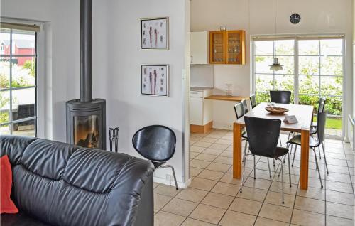 a living room with a couch and a table with a fireplace at 4 Bedroom Lovely Home In Nørre Nebel in Lønne Hede