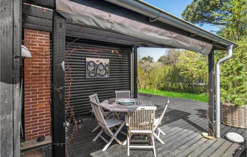 a patio with a table and chairs on a deck at Beautiful Home In Nykøbing Sj With Wifi in Nyrup