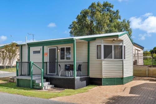 a green and white mobile home with a gate at Discovery Parks - Coogee Beach in Coogee
