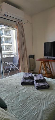 two towels sitting on top of a bed in a room at Palermo Apart 3 in Buenos Aires