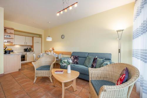 a living room with a couch and chairs and a table at Südwind 37 in Zempin