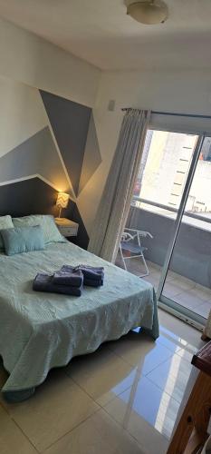a bedroom with a bed with two towels on it at Palermo Apart 3 in Buenos Aires
