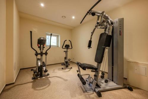 a gym with several tread machines in a room at Südwind 37 in Zempin