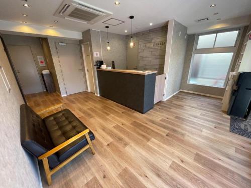 a lobby with a bench and a bar in a room at JA Hotel Namba in Osaka