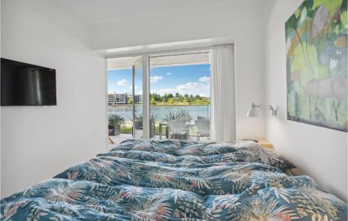 a bedroom with a bed and a large window at 1 Bedroom Nice Apartment In Sønderborg in Sønderborg