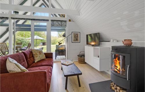 a living room with a couch and a fireplace at 2 Bedroom Nice Home In Aabenraa in Loddenhøj