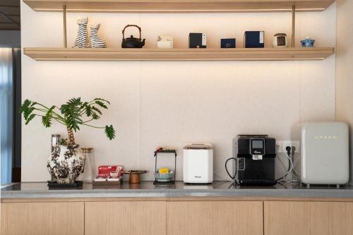 a kitchen with a counter top with two coffee machines at Constellation XingSu Boutique Hotel in Huangshan