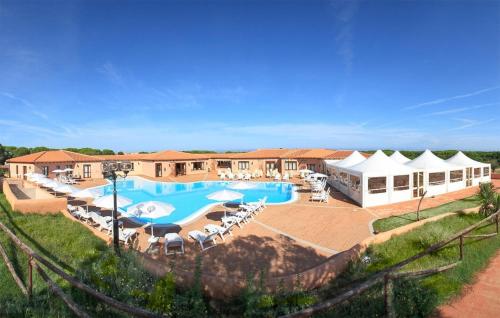 a resort with a large swimming pool and lounge chairs at Vignola Baia Dei Mirti M3 in Vignola Mare
