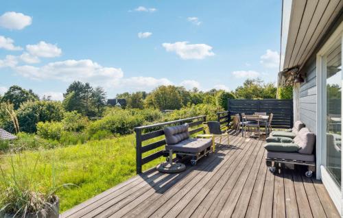 a wooden deck with chairs and a table on it at Awesome Home In Kalundborg With Wifi in Kalundborg