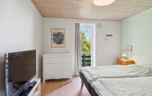 a bedroom with a bed and a flat screen tv at Awesome Home In Kalundborg With Wifi in Kalundborg