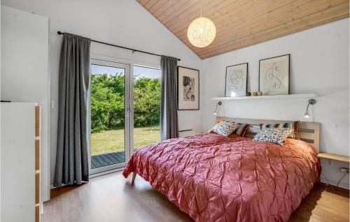 a bedroom with a bed and a large window at Amazing Home In Tarm With Kitchen in Tarm