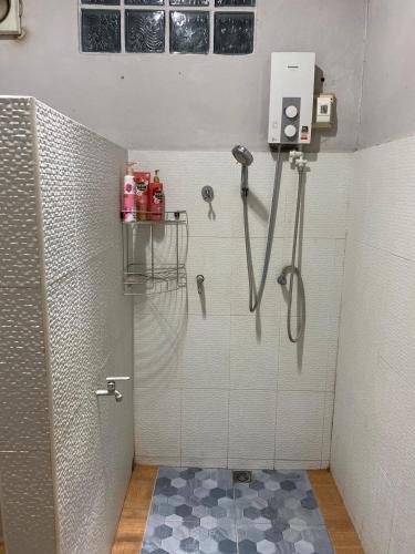 a shower in a bathroom with a shower at Coco Residence, Si Saket in Khun Han