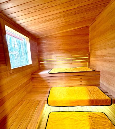 a sauna with two beds in a wooden room at Second House sch-sch(スクスク） in Kita-karuizawa