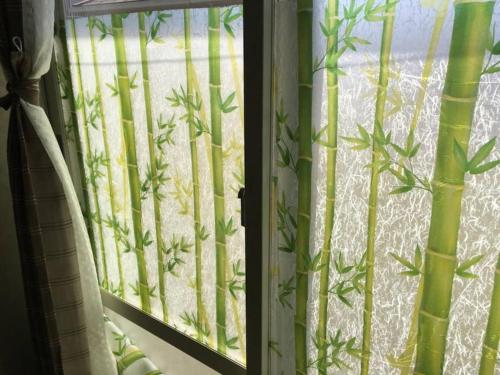 an open window with a curtain with bamboo at JR羽村駅徒歩14分凝った内装でゆったり2DKb203 in Hamura