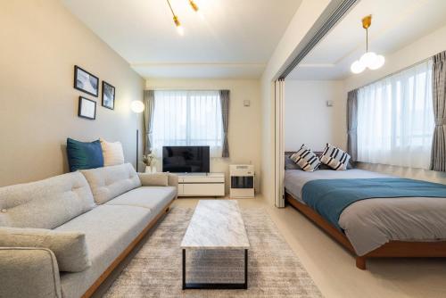 a living room with a bed and a couch at Universe in Sapporo