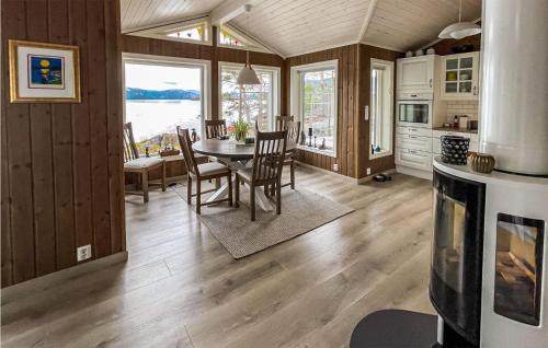 a kitchen and dining room with a table and chairs at Nice Home In Nissedal With Lake View in Kyrkjebygdi