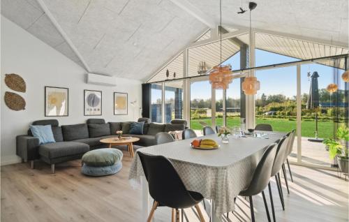 a living room with a table and a couch at Amazing Home In Glesborg With Wifi in Glesborg
