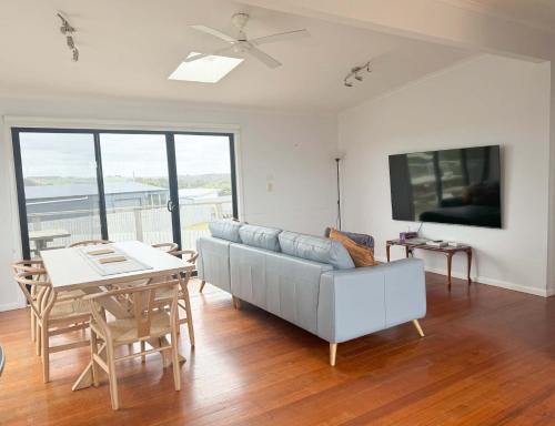 a living room with a couch and a table at Ocean View Getaway in Port Campbell