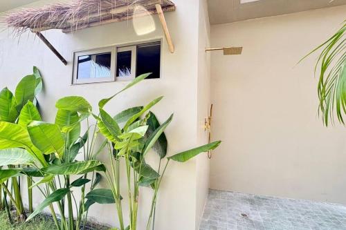 a room with plants in front of a building at Villa Cefloralie - A Tranquil Retreat in Koh Samui in Koh Samui