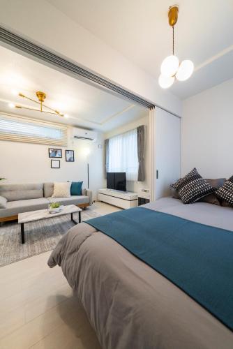 a bedroom with a large bed and a couch at Union in Sapporo
