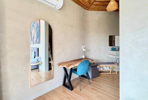 a table and a chair in a room with a mirror at Villa Cefloralie - A Tranquil Retreat in Koh Samui in Koh Samui