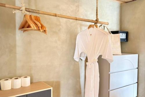 a white shirt hanging on a hanger in a kitchen at Villa Cefloralie - A Tranquil Retreat in Koh Samui in Koh Samui