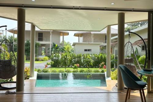 a swimming pool in the middle of a house at Villa Cefloralie - A Tranquil Retreat in Koh Samui in Koh Samui