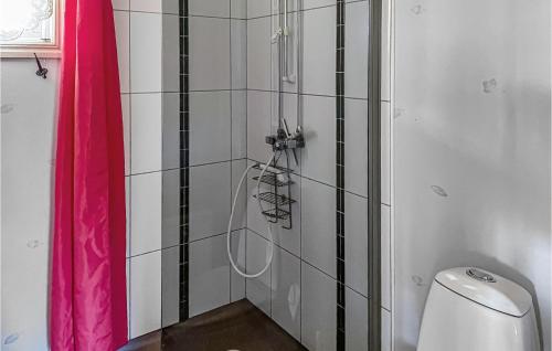 a shower in a bathroom with a pink shower curtain at 3 Bedroom Nice Home In Vittaryd in Kvänarp