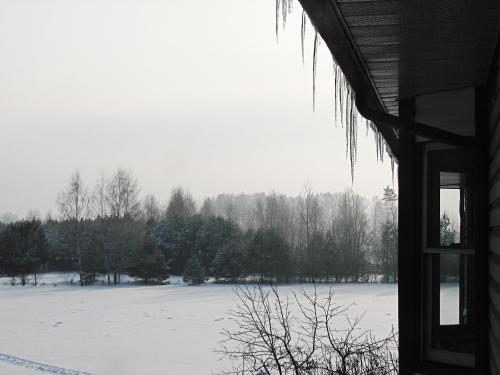 a view of a snow covered field from a house at Airport Hotel Mara in Rīga