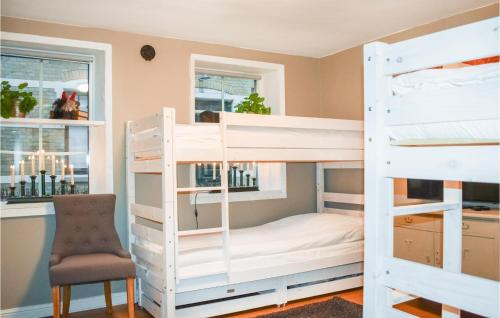 a bedroom with bunk beds with a desk and a chair at 1 Bedroom Amazing Apartment In Ystad in Ystad