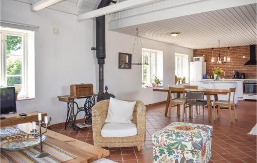 a living room with a table and a dining room at Cozy Home In Gärsnäs With Wifi in Gärsnäs