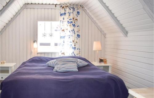 a bed with a purple blanket in a room at Cozy Home In Gärsnäs With Wifi in Gärsnäs