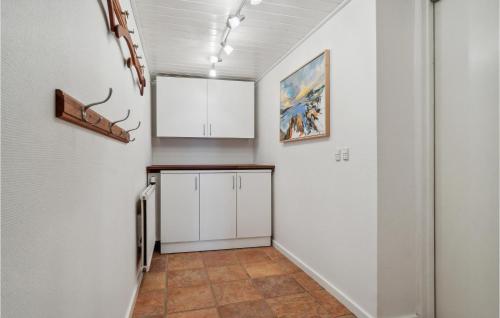a hallway with white walls and a refrigerator at Nice Home In Nexø With Wifi in Neksø