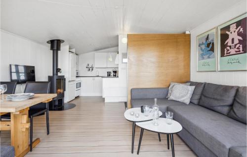 a living room and kitchen with a couch and tables at Gorgeous Home In Munkebo With Kitchen in Munkebo