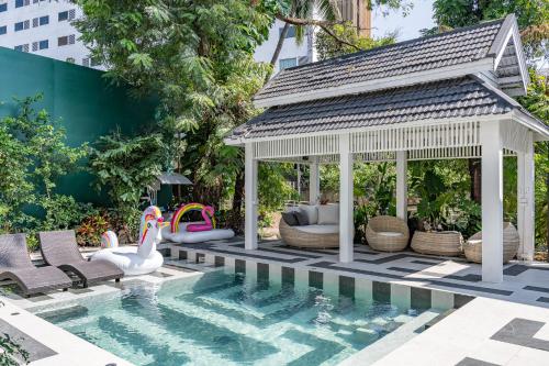 a gazebo by a swimming pool with a gazebo at CLEOPATRA POOL VILLA I Prime Location - Near The Famous Night Bazzar, 5 Minutes from the old city I Daily Housekeeping in Chiang Mai