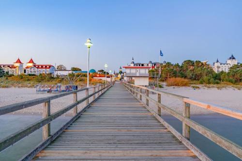 a wooden bridge over the water on a beach at Südwind 12 in Zempin