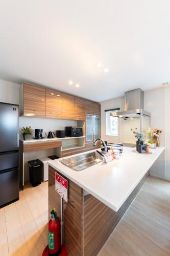 a kitchen with a sink and a counter top at The Verite in Asahikawa