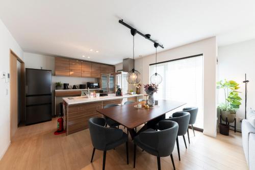 a kitchen and dining room with a table and chairs at The Verite in Asahikawa