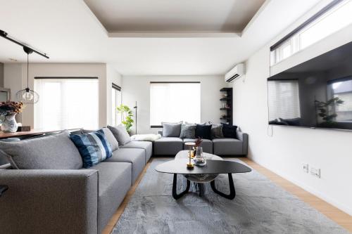 a living room with a couch and a table at The Verite in Asahikawa